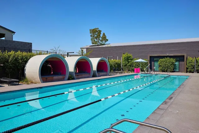 a view of a house with swimming pool and sitting area