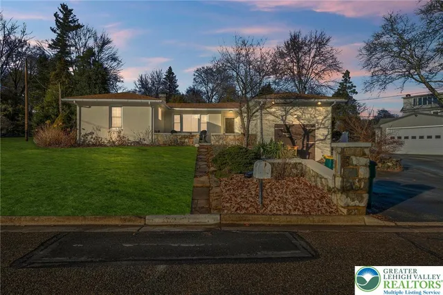a front view of a house with garden