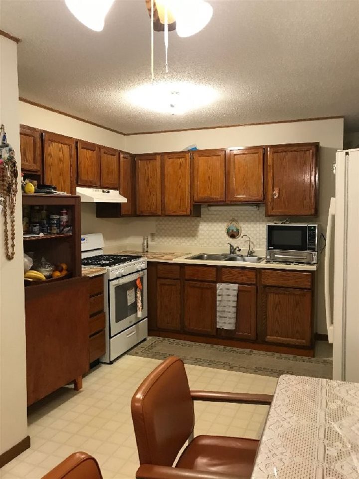 515 South 12th Street Rochelle, IL 61068 - Photo 3 of 25 a kitchen with stainless steel appliances kitchen island granite countertop a stove a sink and a refrigerator