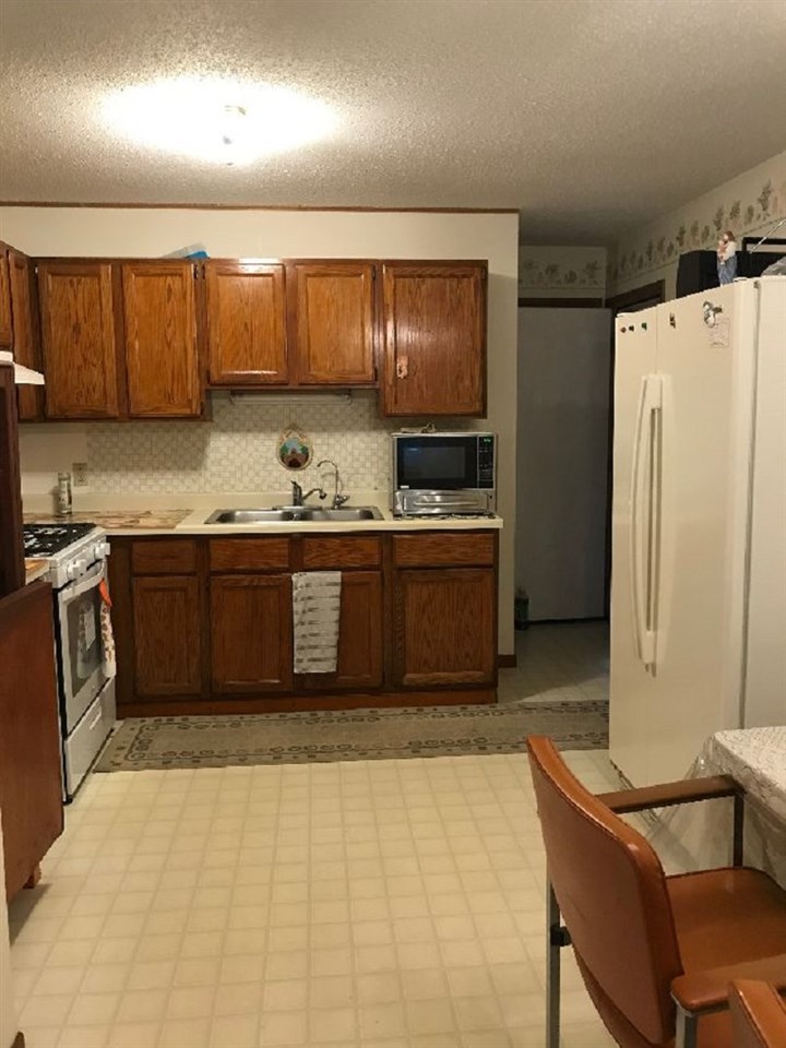 515 South 12th Street Rochelle, IL 61068 - Photo 4 of 25 a kitchen with stainless steel appliances granite countertop a sink stove and refrigerator
