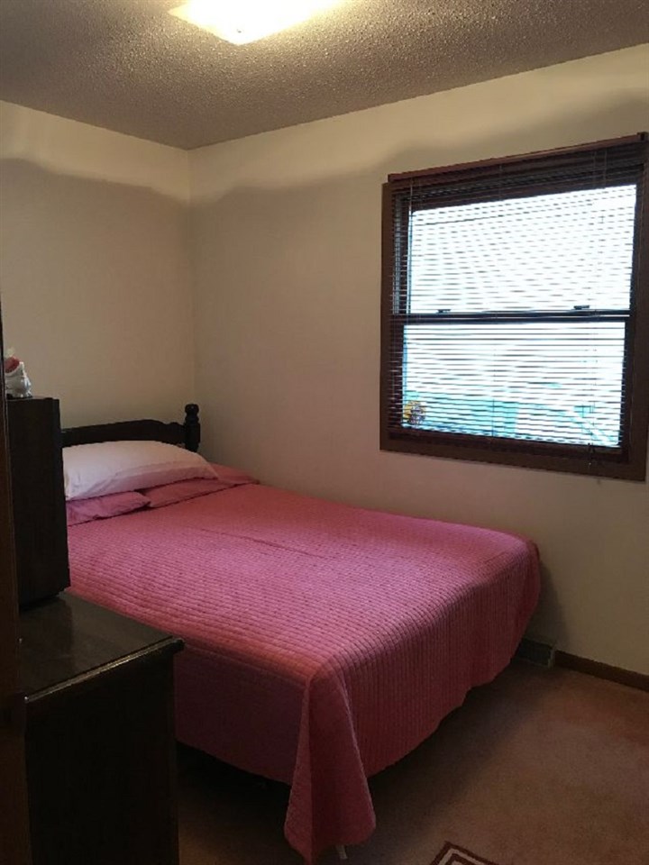 515 South 12th Street Rochelle, IL 61068 - Photo 7 of 25 a bedroom with a bed and a window