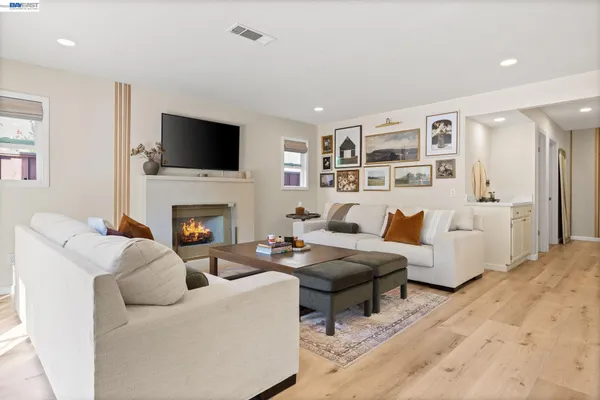 a living room with furniture fireplace and a flat screen tv