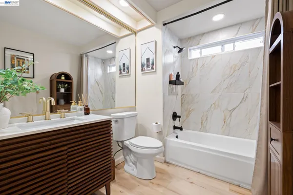 a bathroom with a double vanity sink toilet mirror and shower