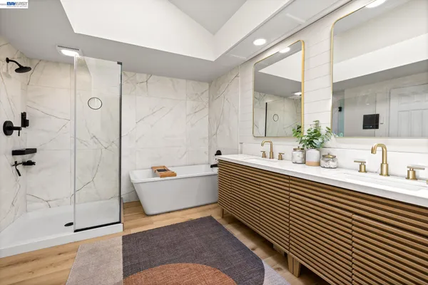 a bathroom with a double vanity sink mirror and shower