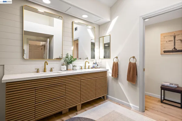 a bathroom with a double vanity sink and mirror