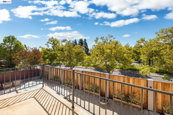 a view of a balcony with wooden fence