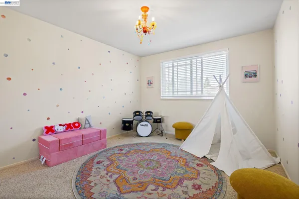 a bedroom with furniture and a window