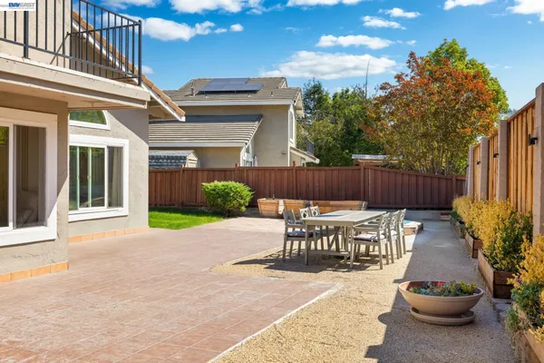 a view of a patio with table and chairs and potted plants