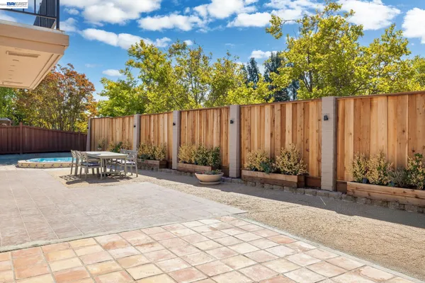 a view of a chair and table in the backyard