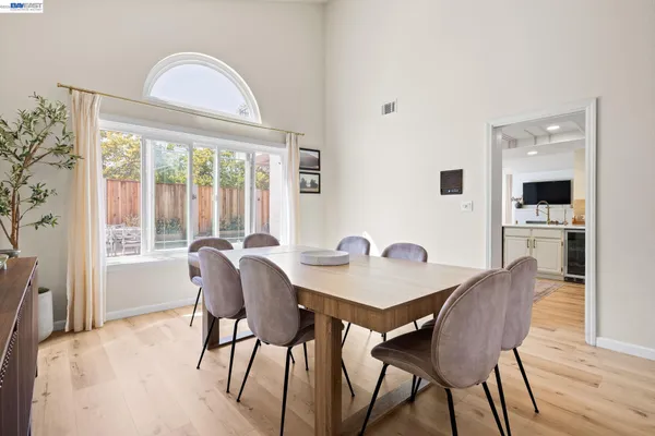 a view of a dining room with furniture window and wooden floor