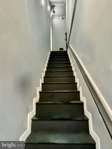 a front view of a building and car parked