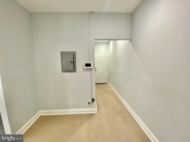 a view of a hallway with a kitchen