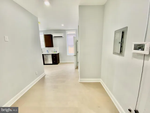 a view of a room with furniture and a flat screen tv