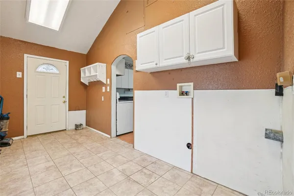 a view of kitchen with refrigerator and cabinets