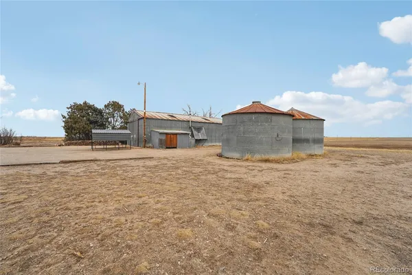 a view of large house with a yard and covered with snow