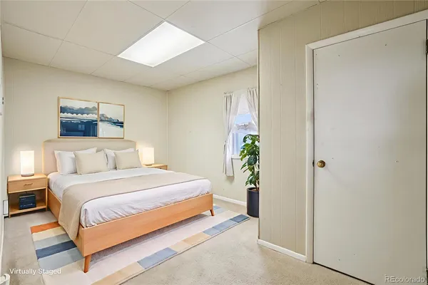 a bedroom with a bed and a painting on the wall