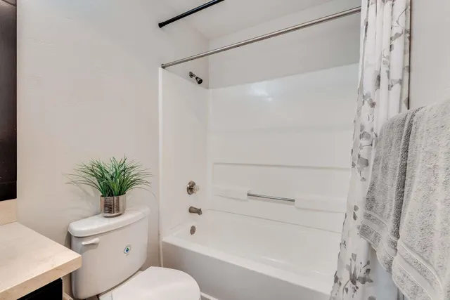a bathroom with a sink vanity mirror and toilet