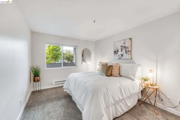 a bedroom with a bed and a lamp on table