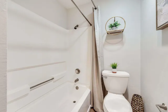a bathroom with a bathtub sink vanity and mirror