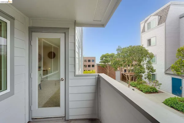 a view of a patio with a table and chairs and garden