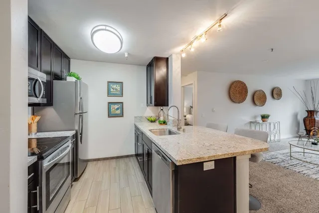 a en suite bathroom with a granite countertop sink and a mirror