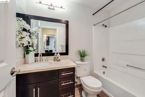 a bathroom with a sink vanity mirror and toilet