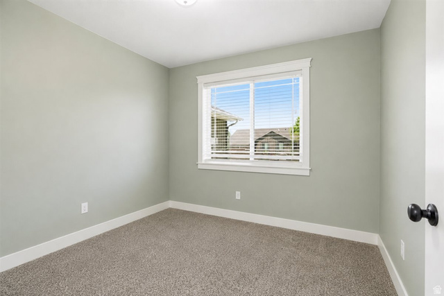 772 East 600 South Preston, ID 83263 - Photo 13 of 35 Neutral-toned room featuring a window with white trim, gray carpet, and light green walls