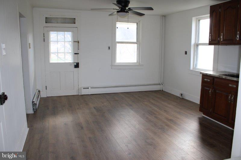 5034 Miller Road Glenville, PA 17329 - Photo 3 of 6 an empty room with wooden floor fan and windows