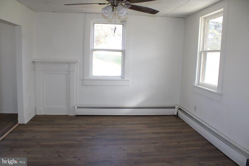 5034 Miller Road Glenville, PA 17329 - Photo 4 of 6 an empty room with wooden floor and windows