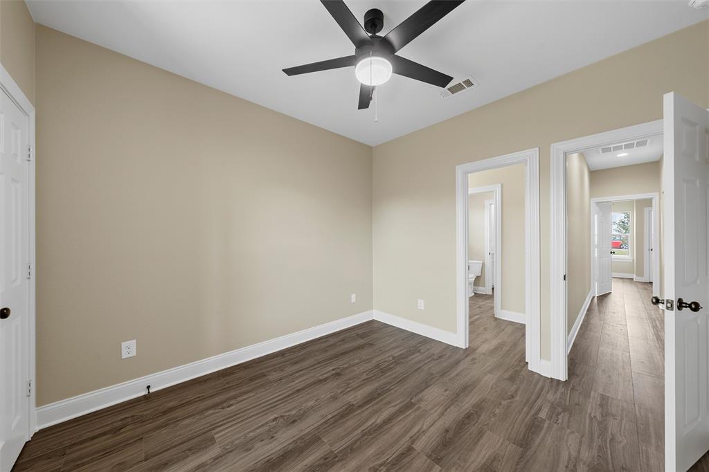 929 Northern Dancer Drive Hewitt, TX 76643 - Photo 21 of 36 an empty room with wooden floor and a ceiling fan