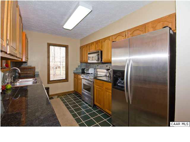 37 Colonial Road Palmyra, VA 22963 - Photo 8 of 22 a kitchen with stainless steel appliances kitchen island granite countertop a refrigerator stove and sink