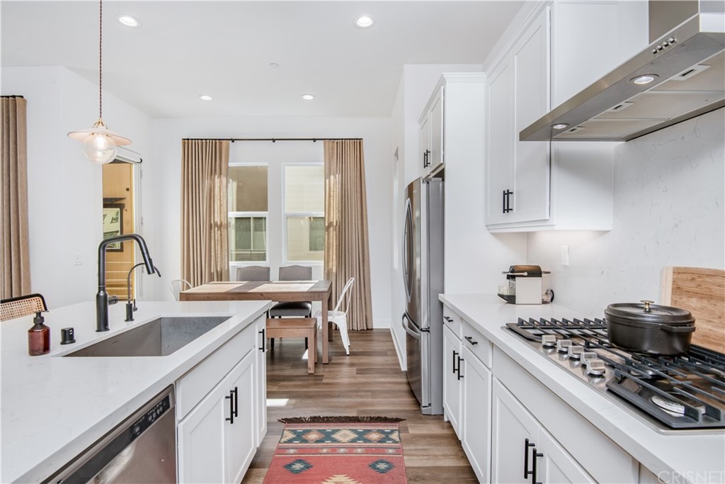 575 Daniel Freeman Circle Inglewood, CA 90301 - Photo 14 of 42 a kitchen with stainless steel appliances a sink stove and refrigerator