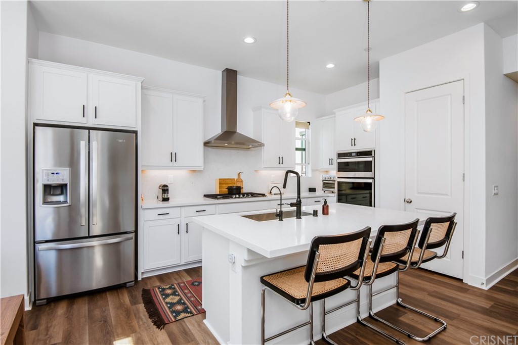 575 Daniel Freeman Circle Inglewood, CA 90301 - Photo 15 of 42 a kitchen with stainless steel appliances a refrigerator a sink a stove a dining table and chairs