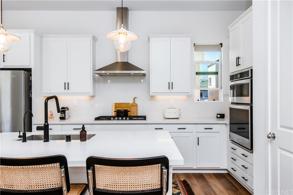 575 Daniel Freeman Circle Inglewood, CA 90301 - Photo 16 of 42 a kitchen with stainless steel appliances a stove a sink a refrigerator and cabinets