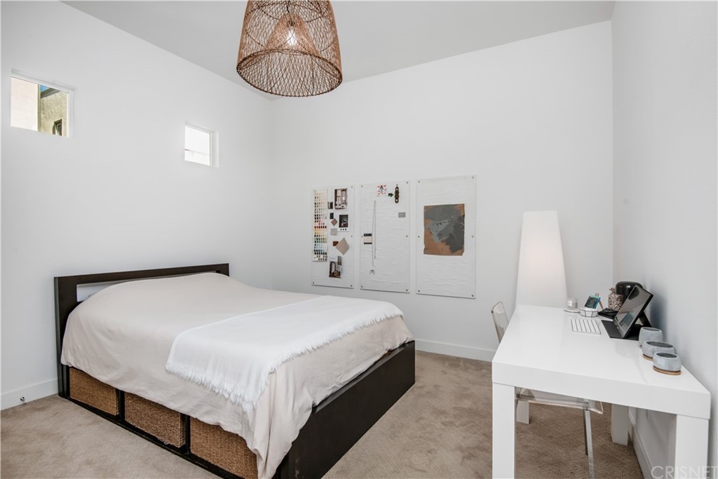 575 Daniel Freeman Circle Inglewood, CA 90301 - Photo 31 of 42 a bedroom with a bed and a chandelier