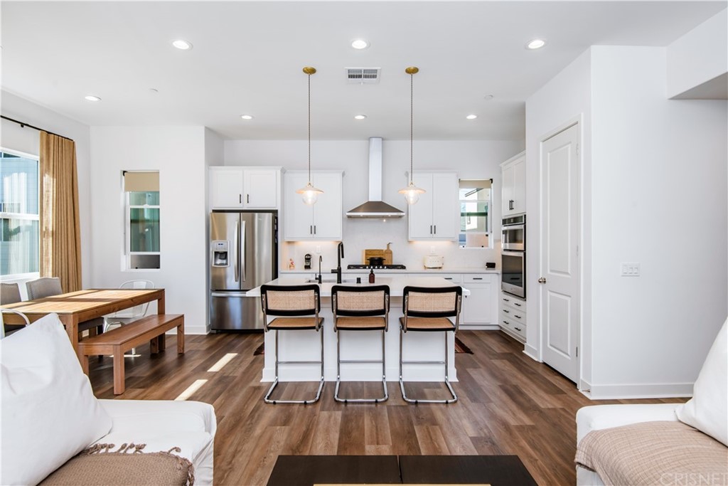 575 Daniel Freeman Circle Inglewood, CA 90301 - Photo 9 of 42 a dining room with kitchen island stainless steel appliances furniture a rug and a fireplace