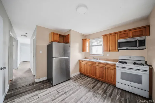 a kitchen with stainless steel appliances a stove a sink and a refrigerator