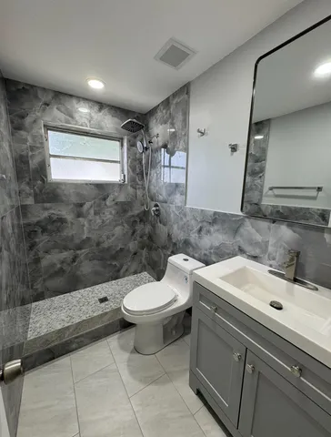 a bathroom with a sink toilet and shower