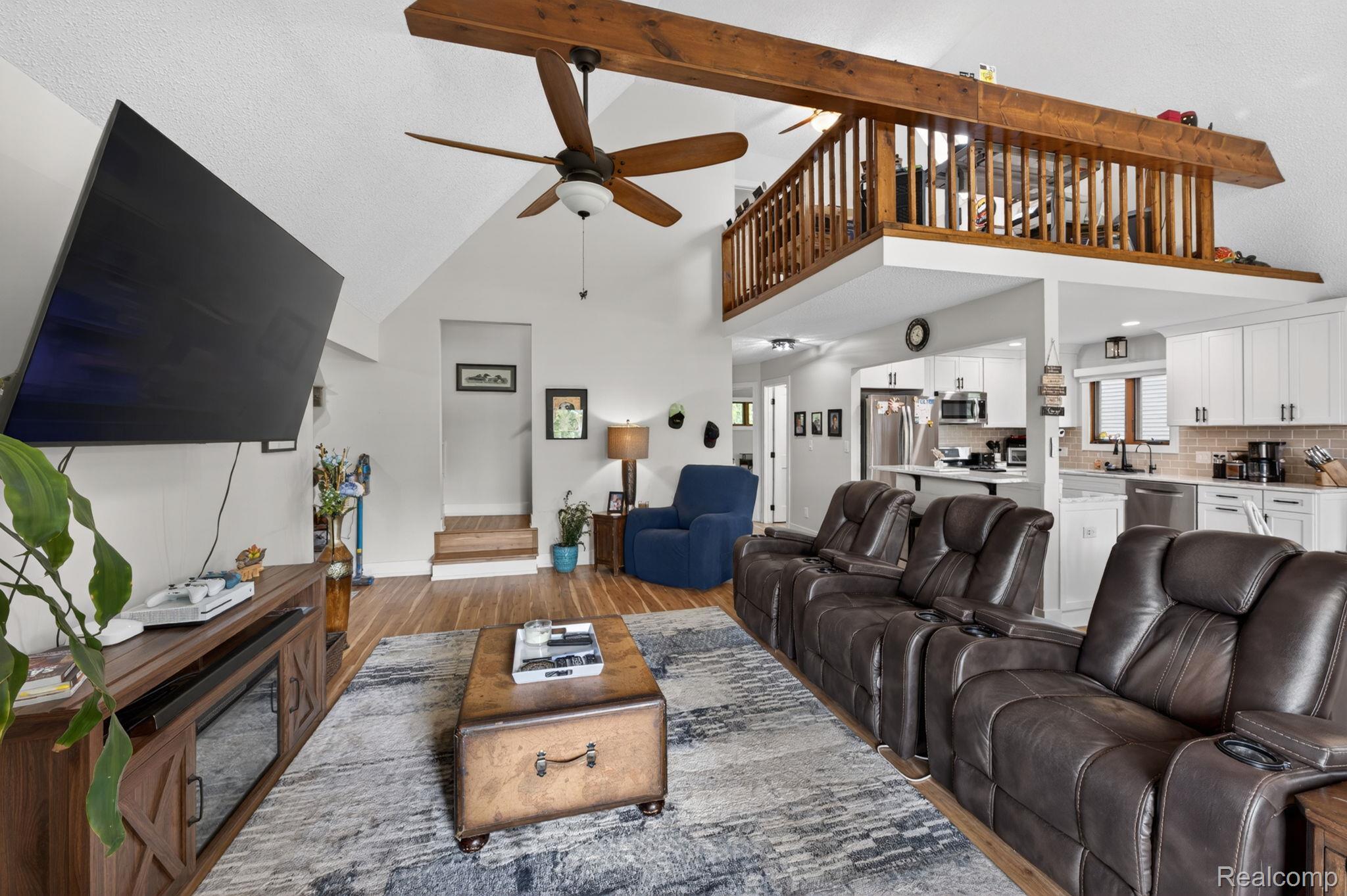 1280 Petts Road Fenton, MI 48430 - Photo 9 of 62 Living area with ceiling fan, wood finished floors, and lofted ceiling