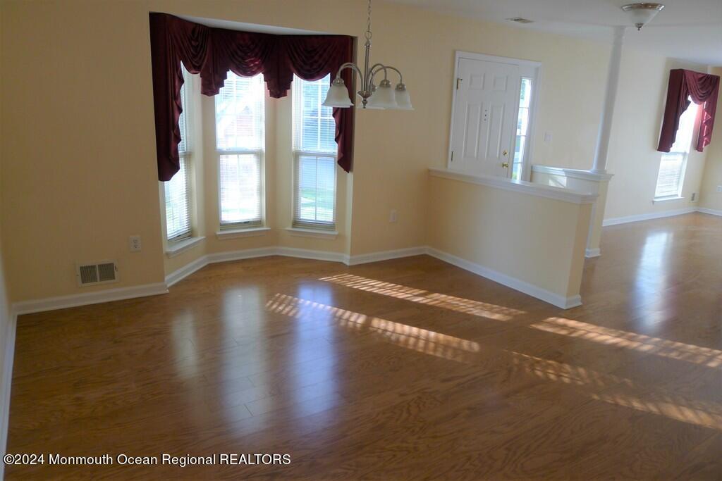5 Oxford Road Holmdel, NJ 07733 - Photo 12 of 16 an empty room with wooden floor and windows