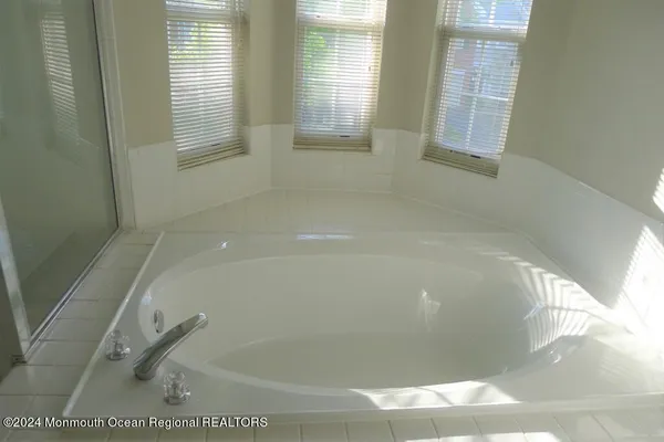 a bath tub sitting in a bathroom next to a window