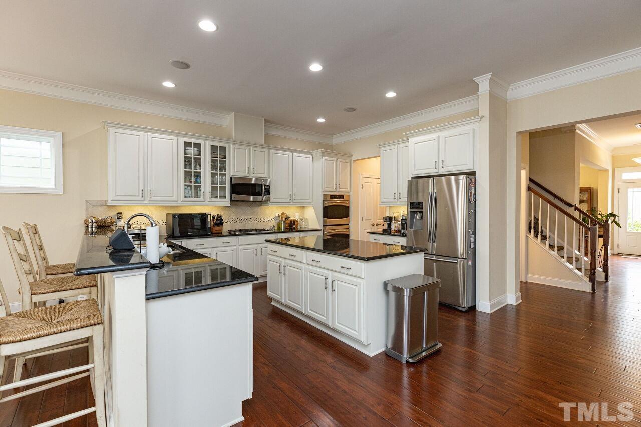 1536 Rodessa Run Raleigh, NC 27607 - Photo 13 of 53 a kitchen with stainless steel appliances a refrigerator stove microwave and cabinets