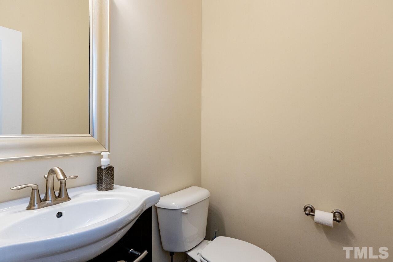 1536 Rodessa Run Raleigh, NC 27607 - Photo 18 of 53 a bathroom with a sink a toilet and a mirror