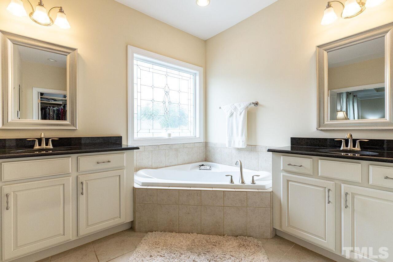 1536 Rodessa Run Raleigh, NC 27607 - Photo 23 of 53 a bathroom with sink bathtub and window