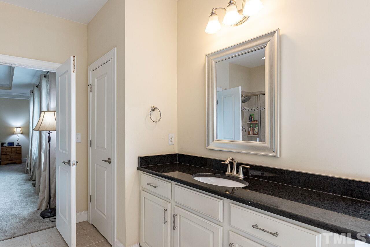 1536 Rodessa Run Raleigh, NC 27607 - Photo 24 of 53 a bathroom with a granite countertop sink and a mirror