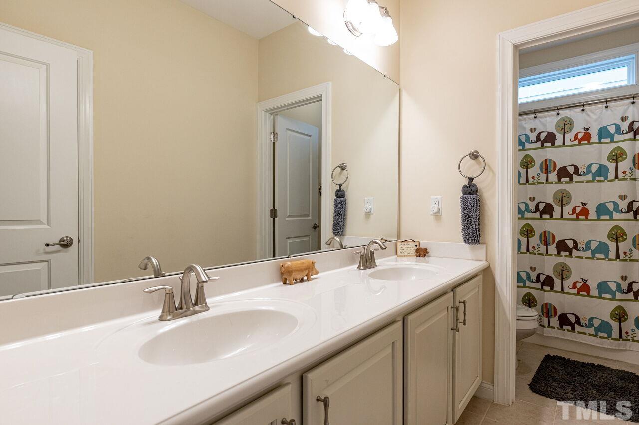 1536 Rodessa Run Raleigh, NC 27607 - Photo 29 of 53 a bathroom with double sink and a mirror