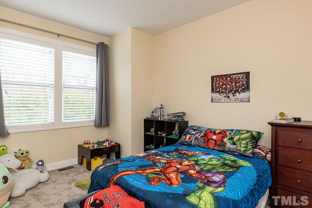1536 Rodessa Run Raleigh, NC 27607 - Photo 30 of 53 a bedroom with a bed and a dresser in it