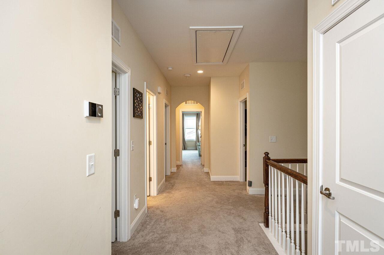 1536 Rodessa Run Raleigh, NC 27607 - Photo 34 of 53 a view of a hallway with wooden shelves