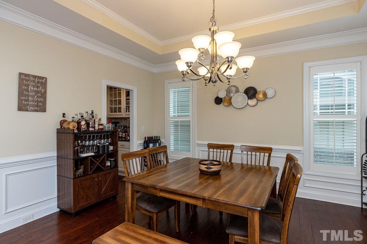 1536 Rodessa Run Raleigh, NC 27607 - Photo 8 of 53 a view of a dining room with furniture wooden floor and chandelier