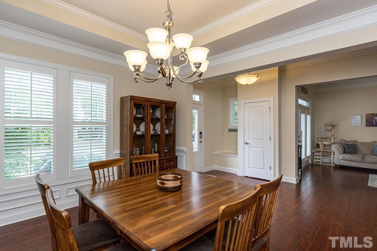 1536 Rodessa Run Raleigh, NC 27607 - Photo 9 of 53 a view of a dining room with furniture wooden floor and chandelier